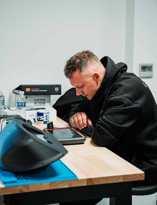 Image of an auto locksmith using a key tool max.