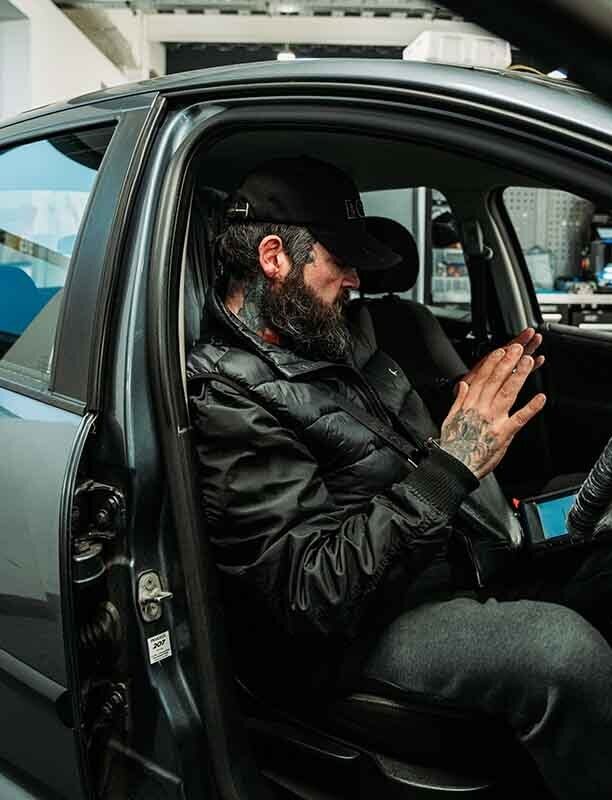 Image of a locksmith working inside a car.