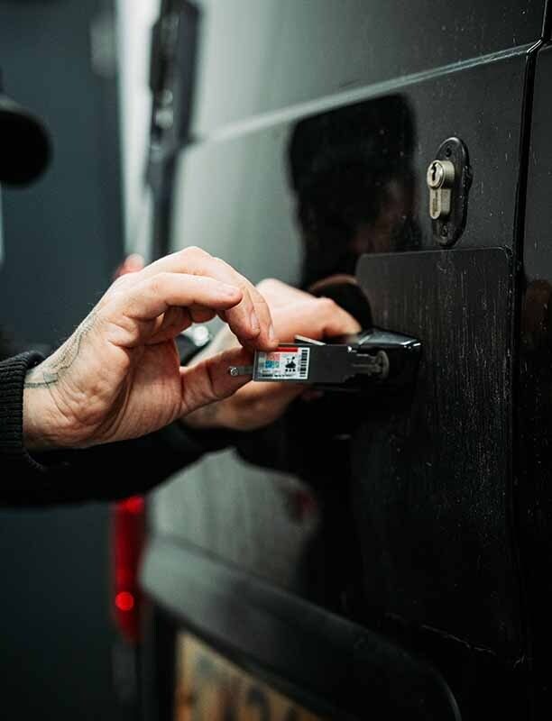 Image of an autolocksmith using a lockpick in a van door.