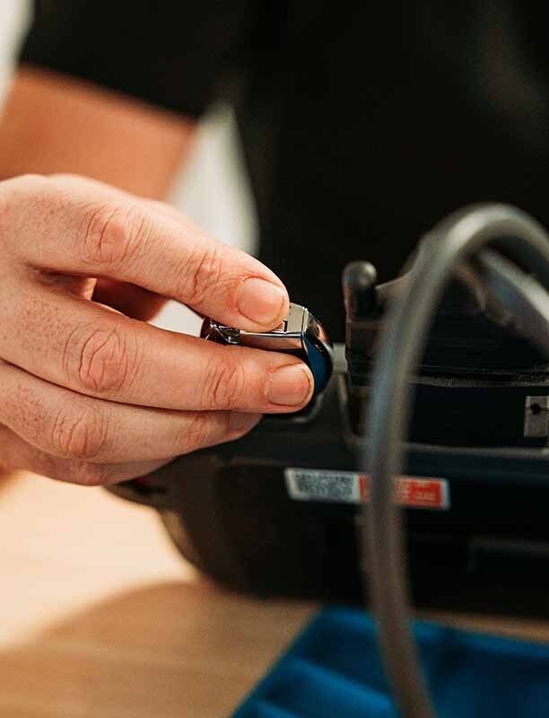 Close-up image of a hand holding a key into a tool.